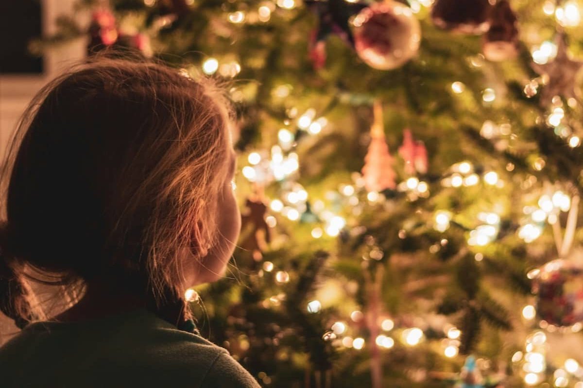 child with christmas tree